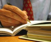 A paralegal writing notes