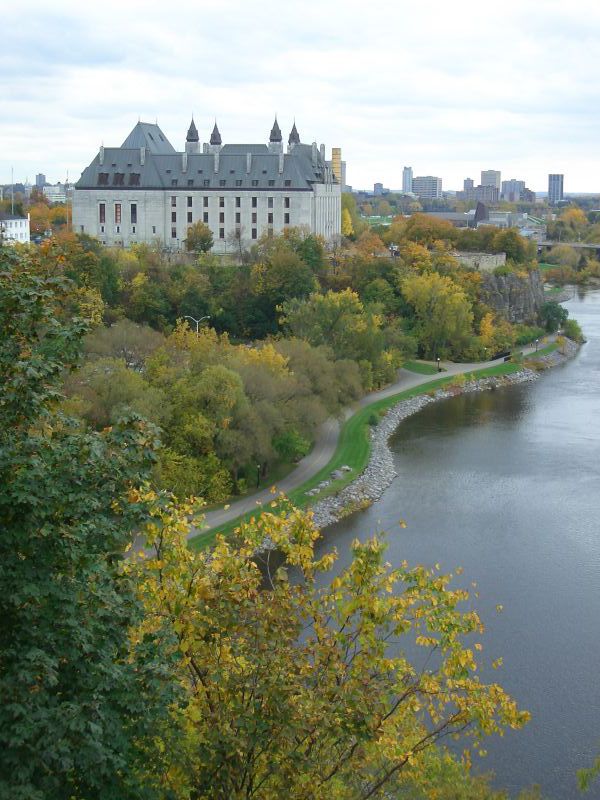 The Supreme Court of Canada overlooking the Ottawa River, surrounded by autumn trees